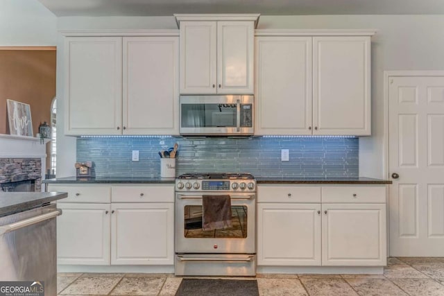 119 Creekside Vw, Hiram, GA 30141 - kitchen featuring stainless steel appliances, white cabinetry, backsplash, and a fireplace