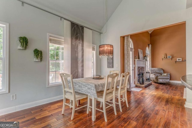 119 Creekside Vw, Hiram, GA 30141 - dining room with vaulted ceiling, hardwood / wood-style floors, and a stone fireplace