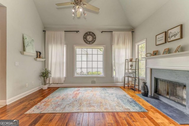 119 Creekside Vw, Hiram, GA 30141 - unfurnished living room featuring ceiling fan, a fireplace with flush hearth, wood finished floors, and high vaulted ceiling