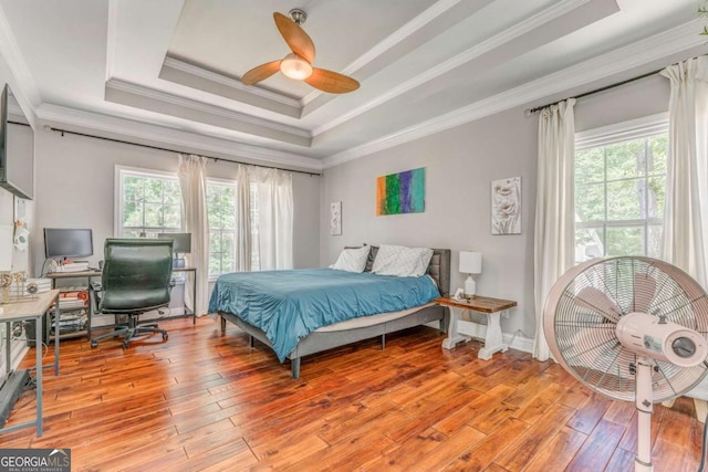 119 Creekside Vw, Hiram, GA 30141 - bedroom featuring a raised ceiling, ornamental molding, light wood-type flooring, a desk, and ceiling fan