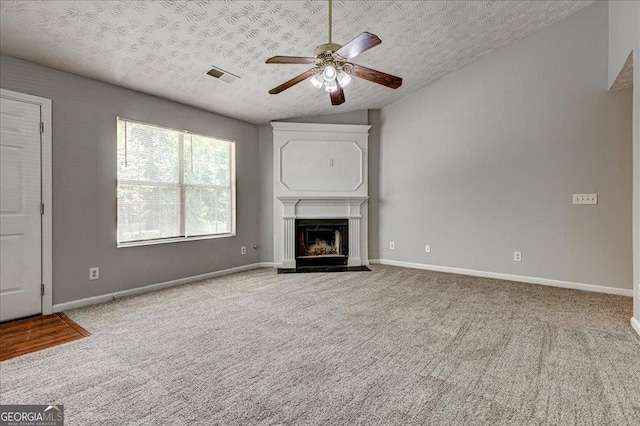2898 Cedar Trace Dr, Ellenwood, GA 30294 - unfurnished living room featuring lofted ceiling, a ceiling fan, a textured ceiling, carpet, and a fireplace