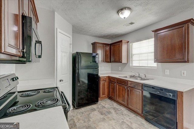 2898 Cedar Trace Dr, Ellenwood, GA 30294 - kitchen with black appliances, light countertops, and a textured ceiling