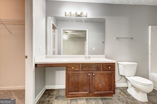 2898 Cedar Trace Dr, Ellenwood, GA 30294 - bathroom featuring vanity, a spacious closet, and ceiling fan