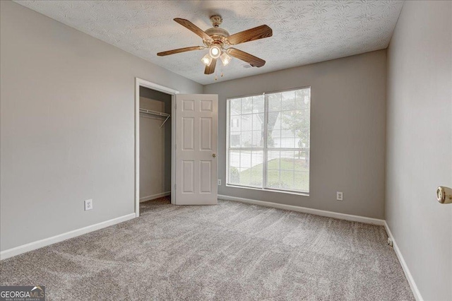 2898 Cedar Trace Dr, Ellenwood, GA 30294 - unfurnished bedroom with carpet, a closet, and ceiling fan