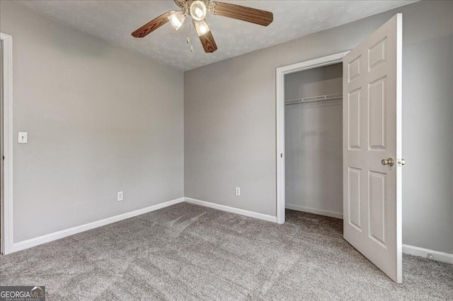 2898 Cedar Trace Dr, Ellenwood, GA 30294 - unfurnished bedroom with carpet, a textured ceiling, a closet, and a ceiling fan