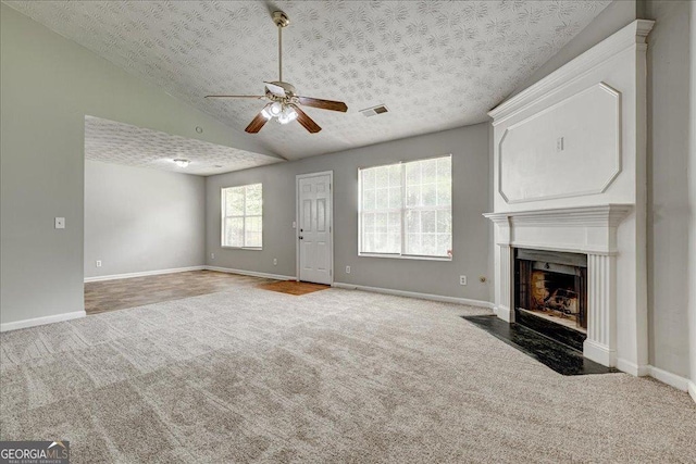 2898 Cedar Trace Dr, Ellenwood, GA 30294 - unfurnished living room with carpet, ceiling fan, a fireplace with flush hearth, and lofted ceiling