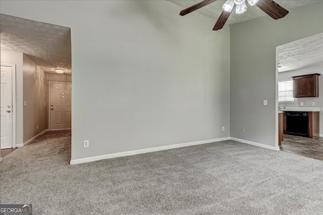 2898 Cedar Trace Dr, Ellenwood, GA 30294 - unfurnished living room featuring a textured ceiling, carpet floors, and ceiling fan