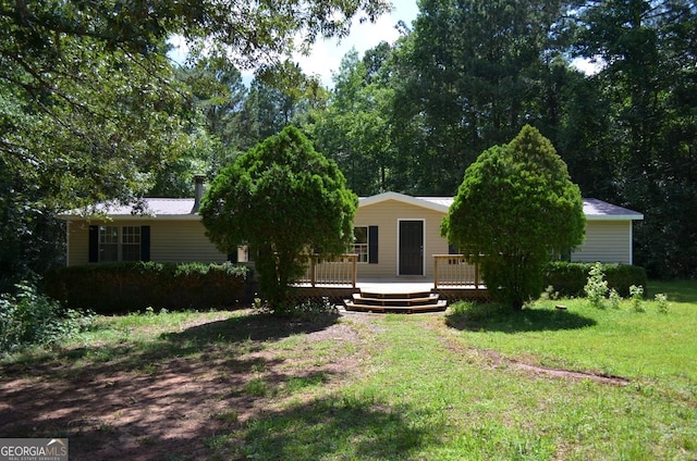 325 High Rd, Forsyth, GA 31029 - view of front of house featuring a deck and a front lawn