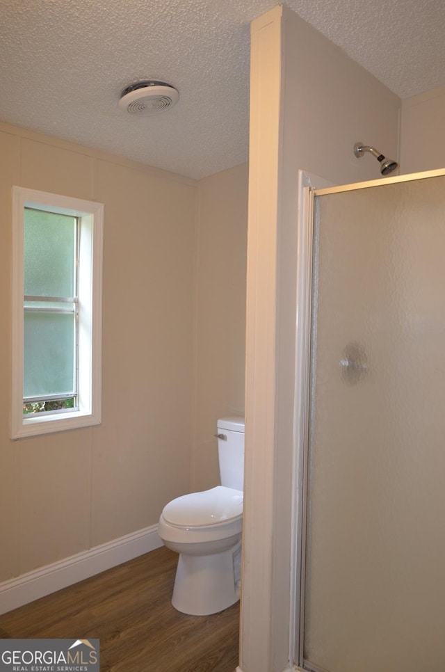 325 High Rd, Forsyth, GA 31029 - full bath featuring wood finished floors, a textured ceiling, and a stall shower