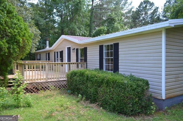 325 High Rd, Forsyth, GA 31029 - view of side of property featuring a wooden deck and a metal roof
