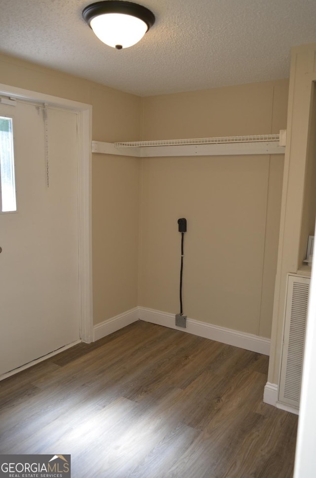 325 High Rd, Forsyth, GA 31029 - laundry area with wood finished floors and a textured ceiling