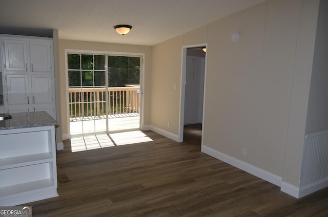 325 High Rd, Forsyth, GA 31029 - unfurnished dining area with dark wood-style floors and baseboards