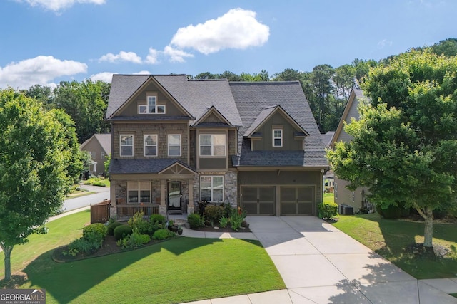 218 Ballymore Ln, Acworth, GA 30102 - craftsman house featuring concrete driveway, an attached garage, a porch, a front yard, and stone siding