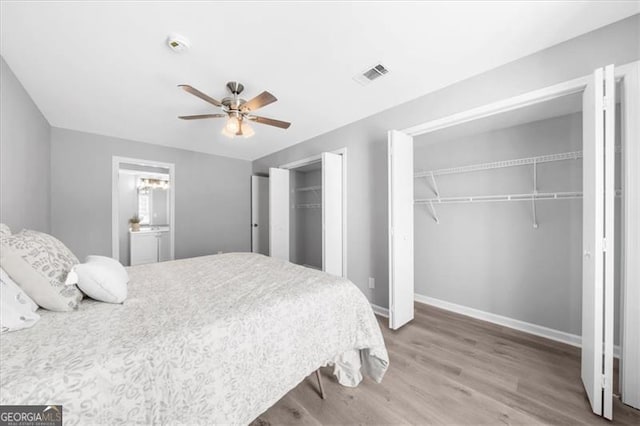 3091 Colonial Way Unit E4, Chamblee, GA 30341 - bedroom with two closets, wood finished floors, and a ceiling fan