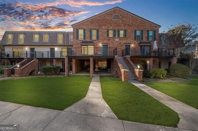 3091 Colonial Way Unit E4, Chamblee, GA 30341 - view of front facade with stairs, a lawn, and brick siding