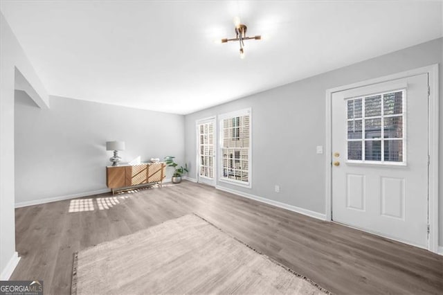 3091 Colonial Way Unit E4, Chamblee, GA 30341 - unfurnished living room featuring baseboards and wood finished floors