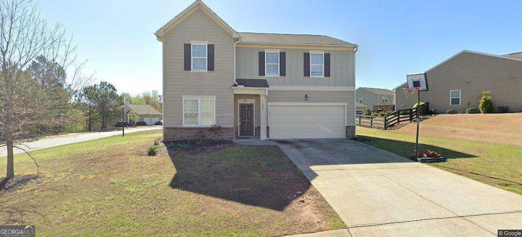 4505 Chandler Dr, Cumming, GA 30028 - traditional-style home with a garage, board and batten siding, concrete driveway, and a front yard