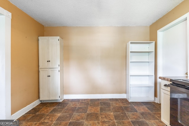 712 Moore Ave, Lafayette, GA 30728 - interior space with a textured ceiling and dark stone finish floors