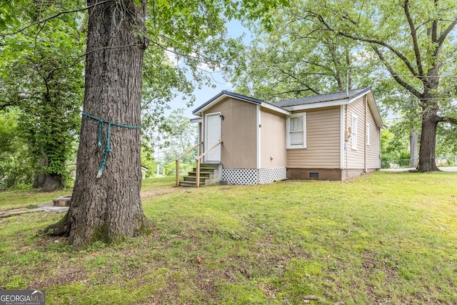 712 Moore Ave, Lafayette, GA 30728 - view of side of home featuring crawl space, entry steps, a yard, and a metal roof