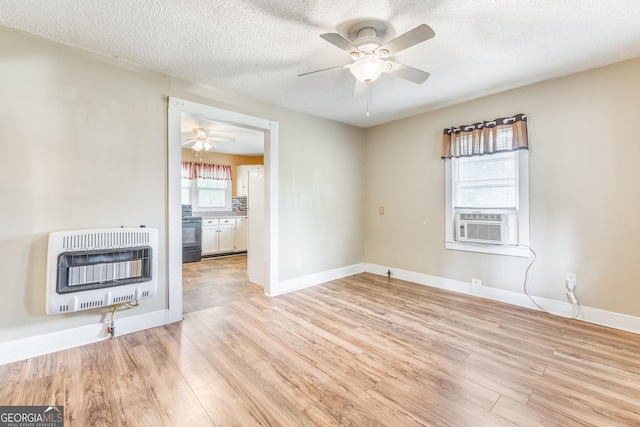 712 Moore Ave, Lafayette, GA 30728 - unfurnished room with heating unit, ceiling fan, light wood finished floors, cooling unit, and a textured ceiling