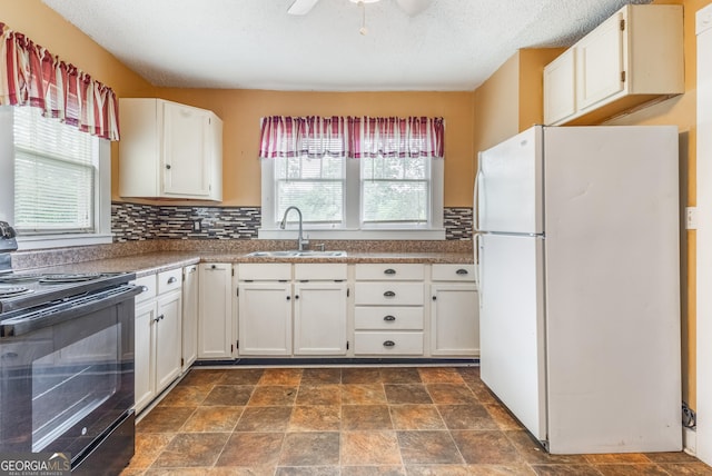 712 Moore Ave, Lafayette, GA 30728 - kitchen featuring freestanding refrigerator, black range with electric stovetop, healthy amount of natural light, ceiling fan, and a textured ceiling