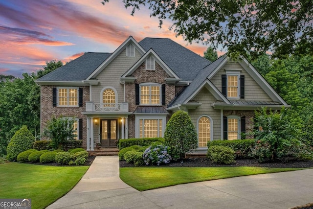 7615 Laurel Oak Dr, Suwanee, GA 30024 - view of front of house with french doors, a front lawn, brick siding, and a shingled roof