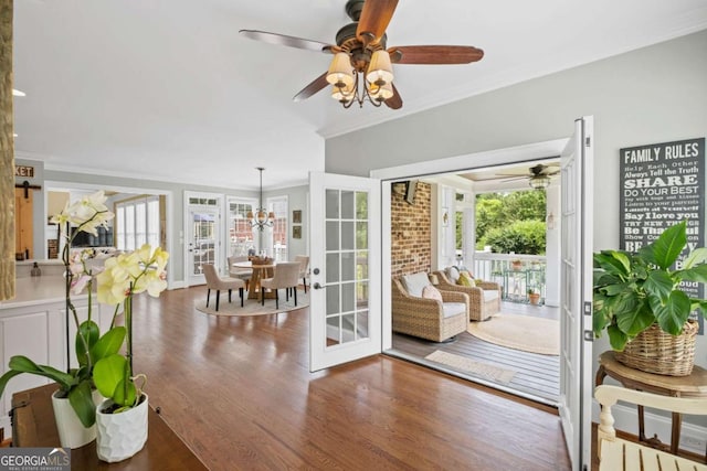 7615 Laurel Oak Dr, Suwanee, GA 30024 - doorway featuring a ceiling fan, crown molding, healthy amount of natural light, wood finished floors, and a chandelier