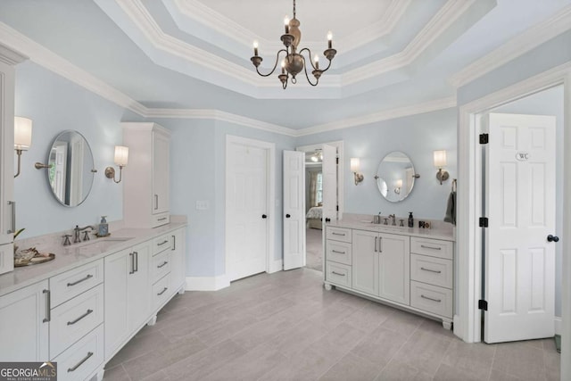 7615 Laurel Oak Dr, Suwanee, GA 30024 - bathroom featuring a chandelier, two vanities, a tray ceiling, crown molding, and ensuite bath