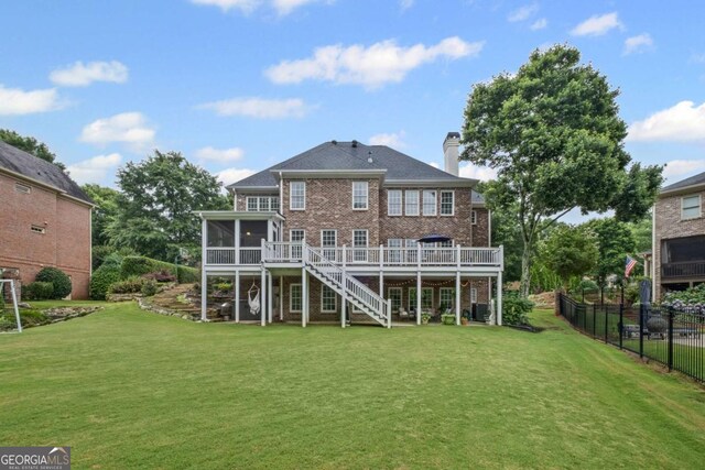 7615 Laurel Oak Dr, Suwanee, GA 30024 - back of house with a sunroom, stairs, a wooden deck, a chimney, and brick siding