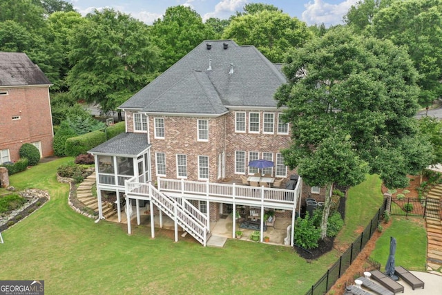 7615 Laurel Oak Dr, Suwanee, GA 30024 - rear view of house with a sunroom, stairs, a patio, roof with shingles, and a deck