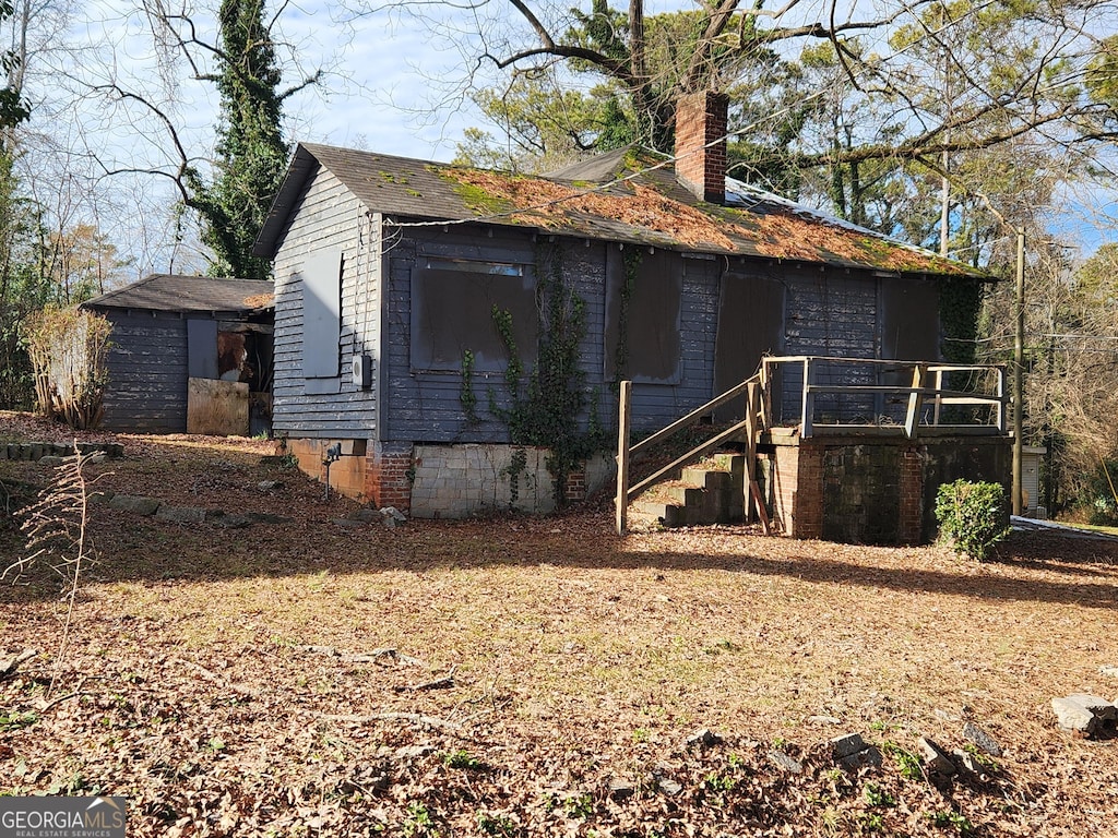 366 Seventh Ave, Scottdale, GA 30079 - view of side of home with a chimney, crawl space, and stairway