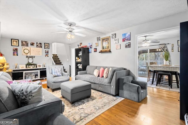 916 Marshall Fuller Rd, Dallas, GA 30157 - living room with a ceiling fan, light wood-style flooring, stairs, and a textured ceiling