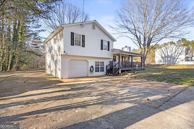 916 Marshall Fuller Rd, Dallas, GA 30157 - split level home featuring concrete driveway, a porch, and an attached garage