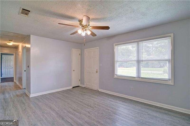 24 Echo Ridge Dr, Powder Springs, GA 30127 - spare room featuring wood finished floors, a textured ceiling, and a ceiling fan