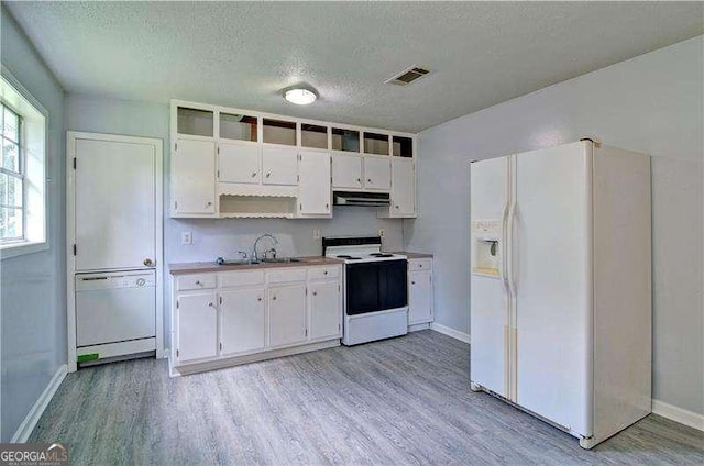24 Echo Ridge Dr, Powder Springs, GA 30127 - kitchen featuring white appliances, extractor fan, light wood-style flooring, a textured ceiling, and white cabinetry