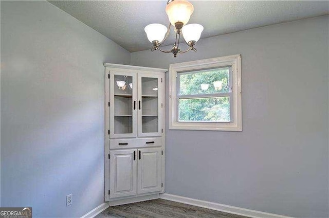 24 Echo Ridge Dr, Powder Springs, GA 30127 - unfurnished dining area featuring a chandelier and wood finished floors