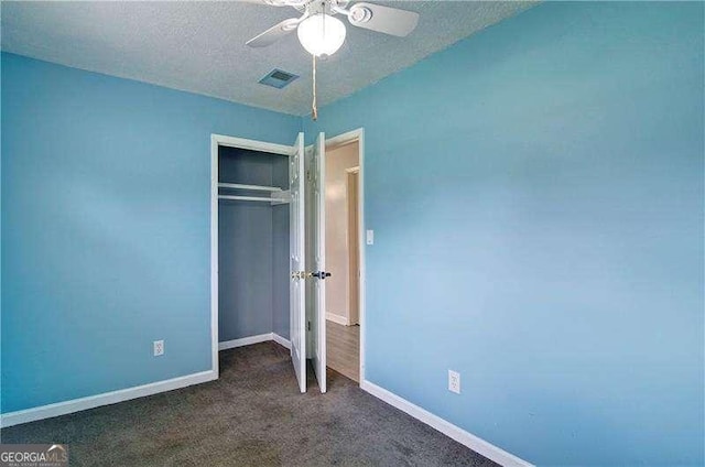 24 Echo Ridge Dr, Powder Springs, GA 30127 - unfurnished bedroom with a closet, dark carpet, a textured ceiling, and ceiling fan