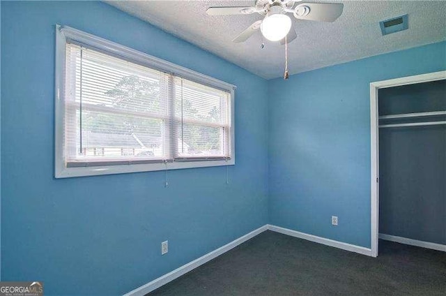 24 Echo Ridge Dr, Powder Springs, GA 30127 - unfurnished bedroom with dark colored carpet, a textured ceiling, a closet, and ceiling fan