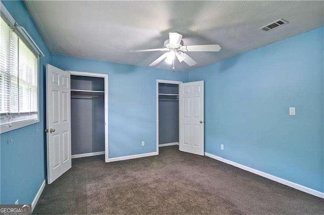 24 Echo Ridge Dr, Powder Springs, GA 30127 - unfurnished bedroom with multiple closets, carpet flooring, and ceiling fan
