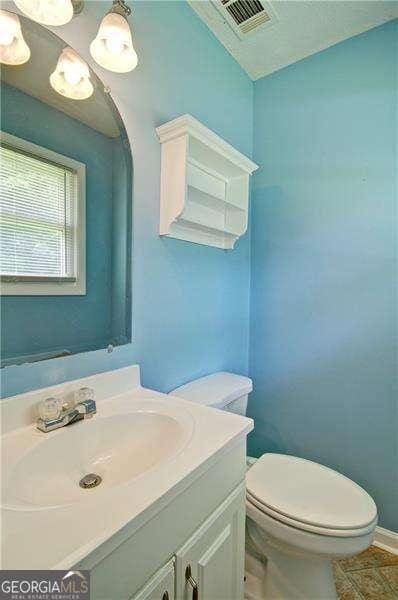 24 Echo Ridge Dr, Powder Springs, GA 30127 - bathroom featuring vanity and vaulted ceiling