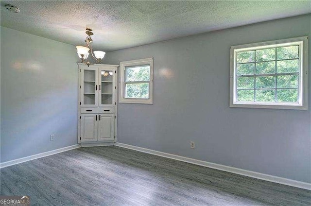24 Echo Ridge Dr, Powder Springs, GA 30127 - spare room with wood finished floors, a chandelier, a smoke detector, and a textured ceiling