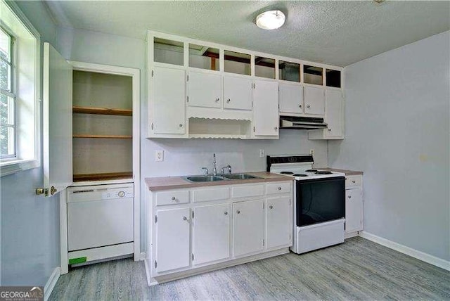 24 Echo Ridge Dr, Powder Springs, GA 30127 - kitchen with white appliances, range hood, light wood-style flooring, open shelves, and a textured ceiling