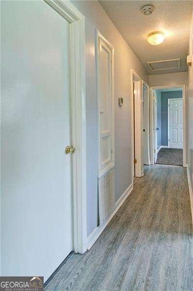24 Echo Ridge Dr, Powder Springs, GA 30127 - corridor with wood finished floors and attic access
