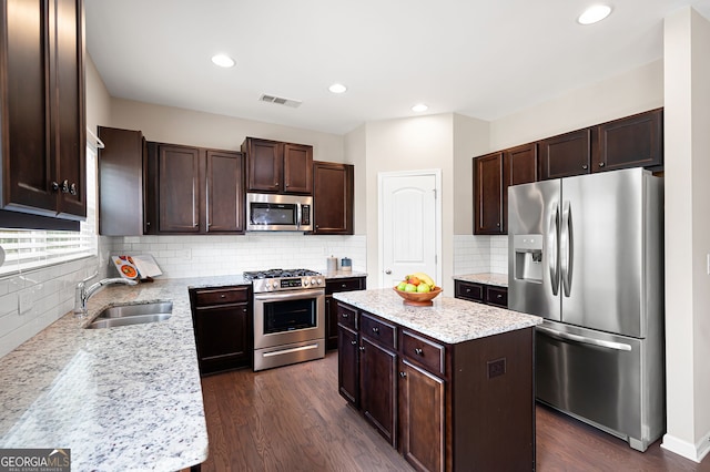 207 Cross Rd, Acworth, GA 30102 - kitchen with stainless steel appliances, dark brown cabinets, dark wood-type flooring, a kitchen island, and recessed lighting
