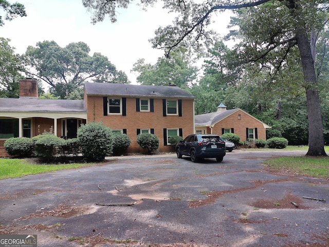 5001 Old Dawson Rd, Albany, GA 31721 - view of front facade featuring brick siding, a chimney, and driveway