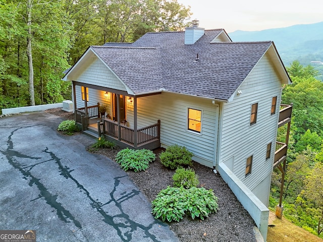 63 Maple Ridge Trl, Clayton, GA 30525 - rustic home with a shingled roof, a porch, a chimney, and a mountain view
