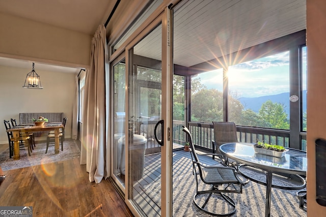 63 Maple Ridge Trl, Clayton, GA 30525 - sunroom with outdoor dining space, plenty of natural light, a mountain view, and a chandelier