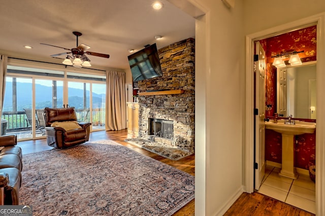 63 Maple Ridge Trl, Clayton, GA 30525 - living room featuring ceiling fan, wood finished floors, a stone fireplace, and recessed lighting