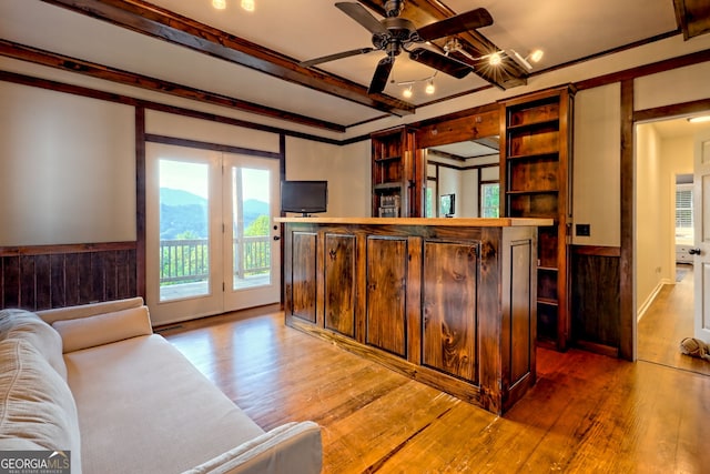 63 Maple Ridge Trl, Clayton, GA 30525 - living room featuring light wood-style flooring, a ceiling fan, ornamental molding, and wainscoting
