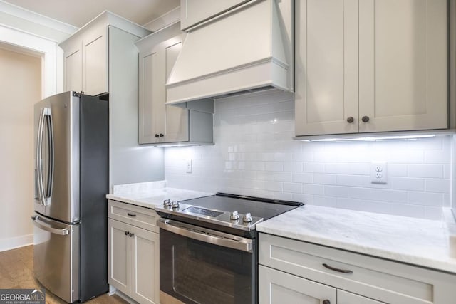 115 Gracetree Way, Kathleen, GA 31047 - kitchen with stainless steel appliances, custom exhaust hood, light wood finished floors, backsplash, and light stone counters